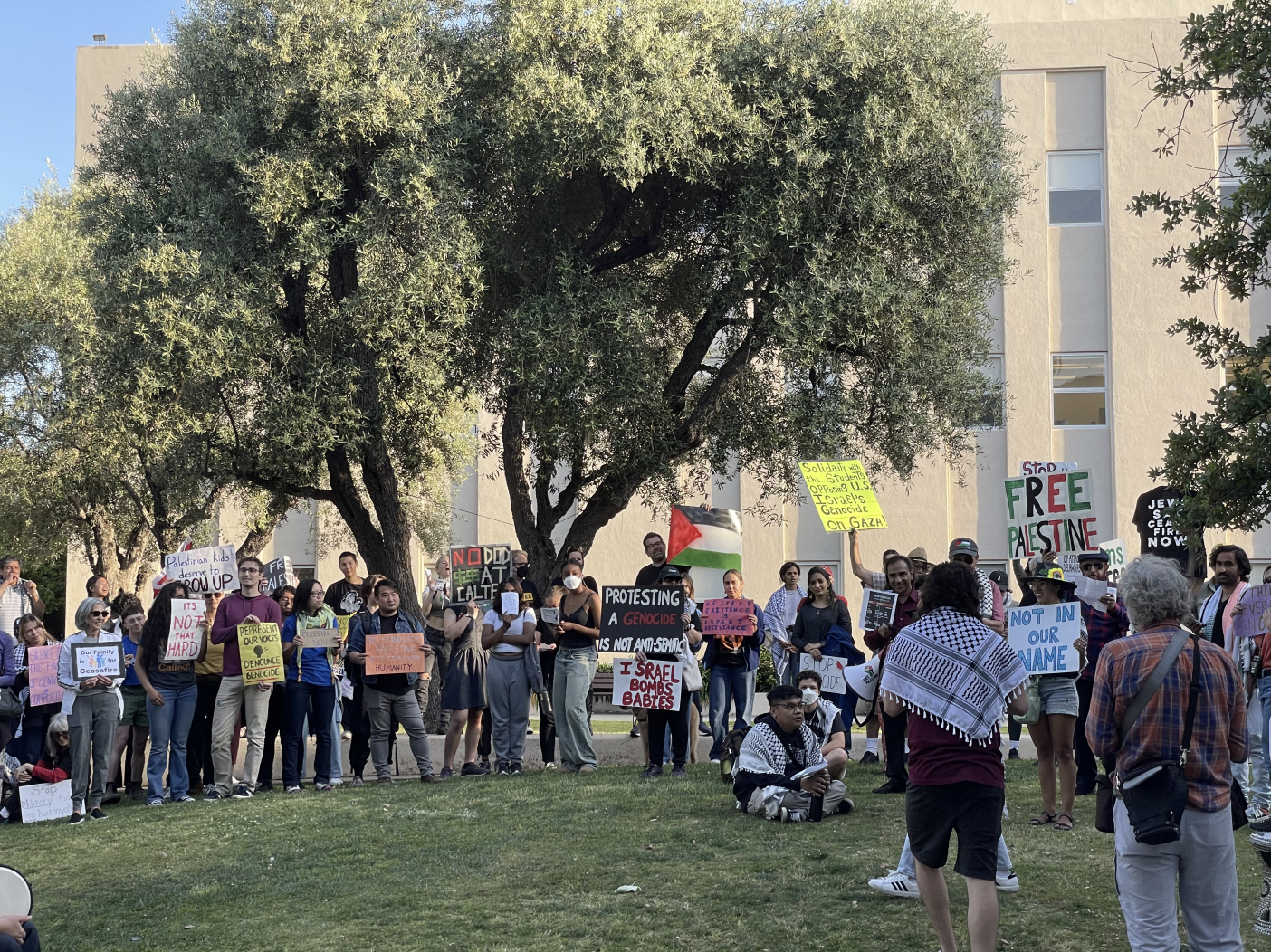 Many protesters (a different group) standing outside Red Door, holding signs as part of the evening march